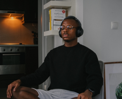 Image of a young man wearing headphones with his eyes closed. This image depicts the relief you can find when meeting with a brainspotting therapist for virtual brainspotting for anxiety in Nashville, TN. 37205 | 37204